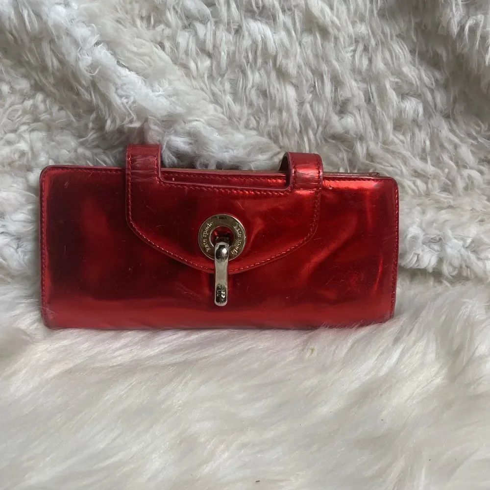 Kate Spade patent leather Red bifold wallet with silver tone hardwares .